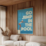 a living room with a large poster on the wall that says "GO JUMP IN THE POOL".