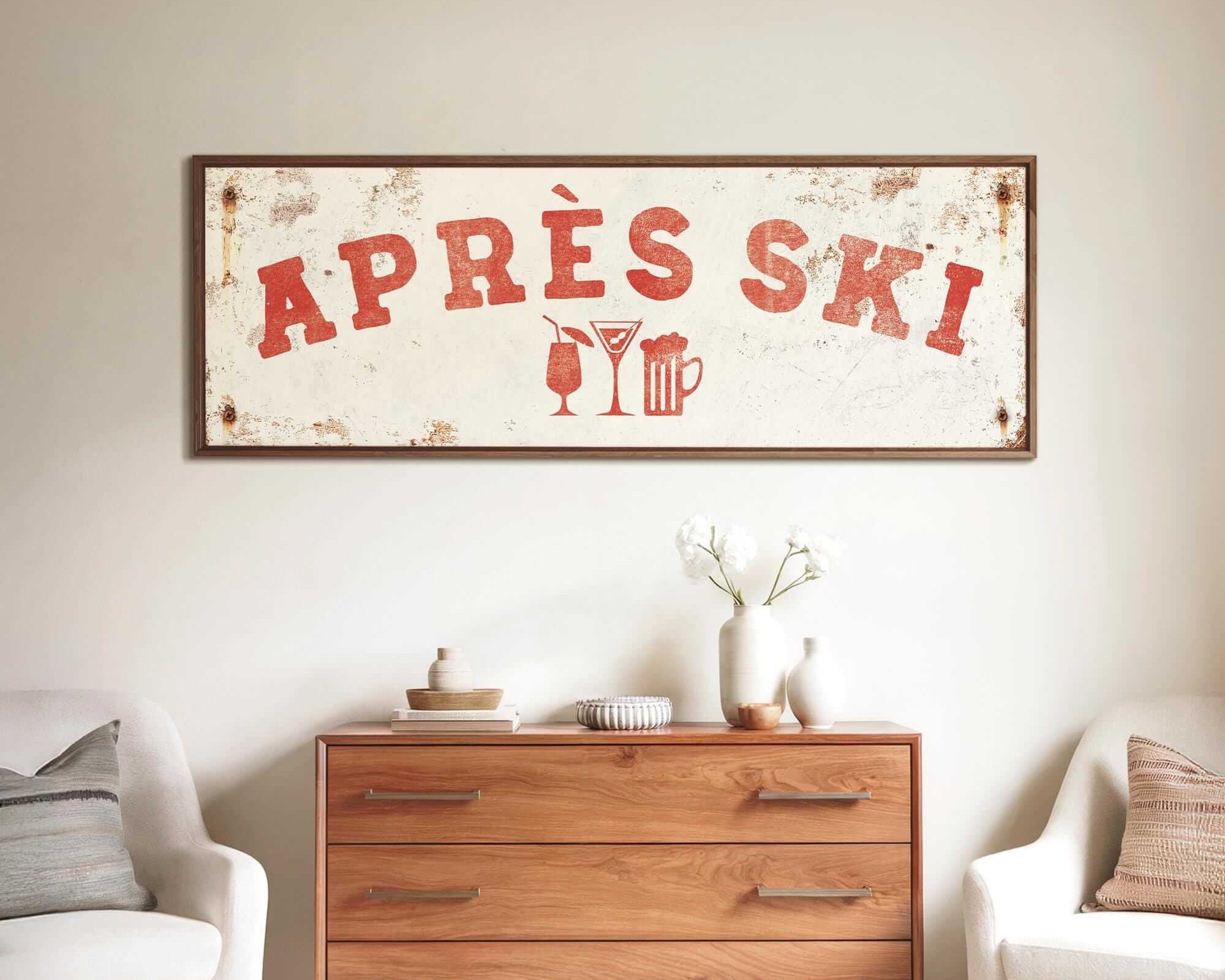 a rustic wooden dresser with a vintage-style sign above it, and two white armchairs placed in front of the dresser.