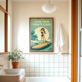 a bathroom with a framed vintage poster of a woman paddleboarding on a lake, a towel hanging on the wall, and a potted plant on the floor.