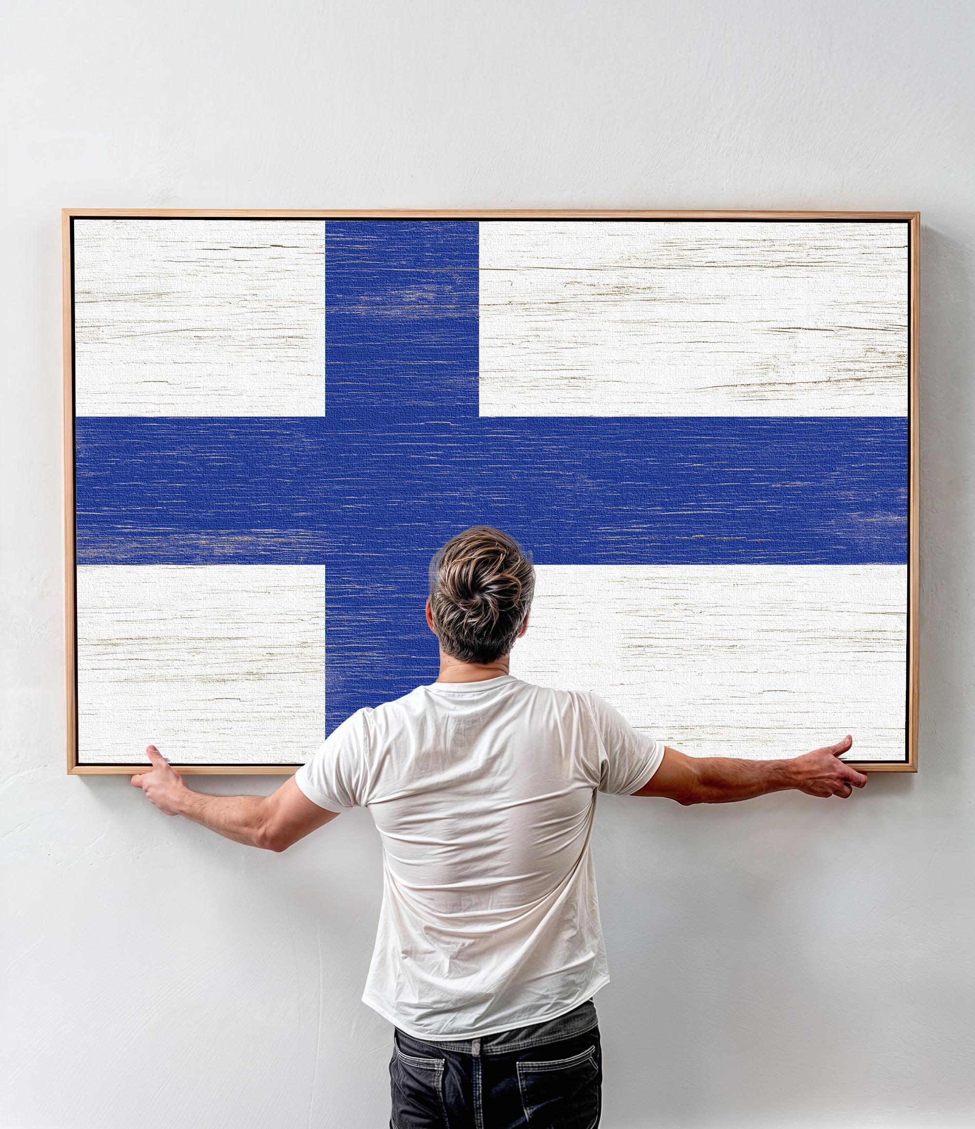 a man standing in front of a painting of a blue and white cross
