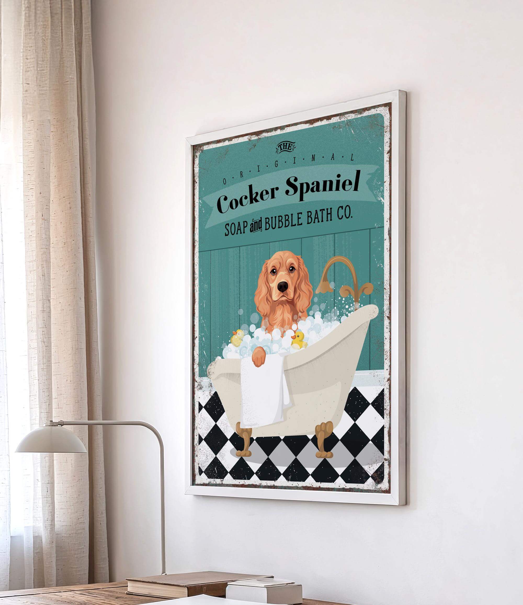 A framed poster of a Cocker Spaniel dog sitting in a bathtub, surrounded by bubbles, is displayed on a wall.