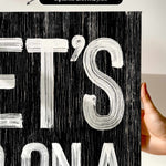 a person holding up a black and white poster
