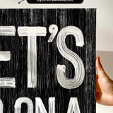 a person holding up a black and white poster