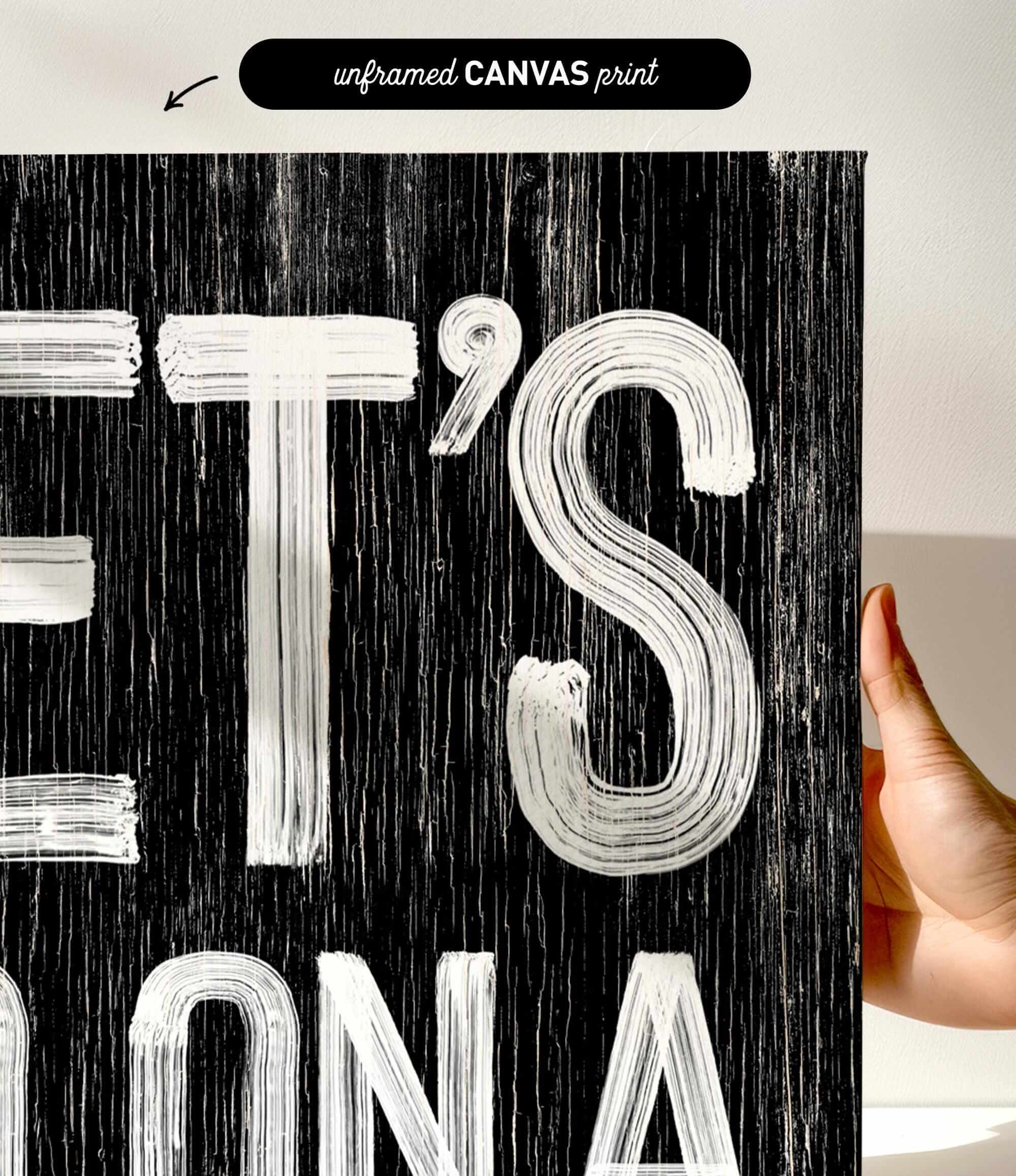 a person holding up a black and white poster