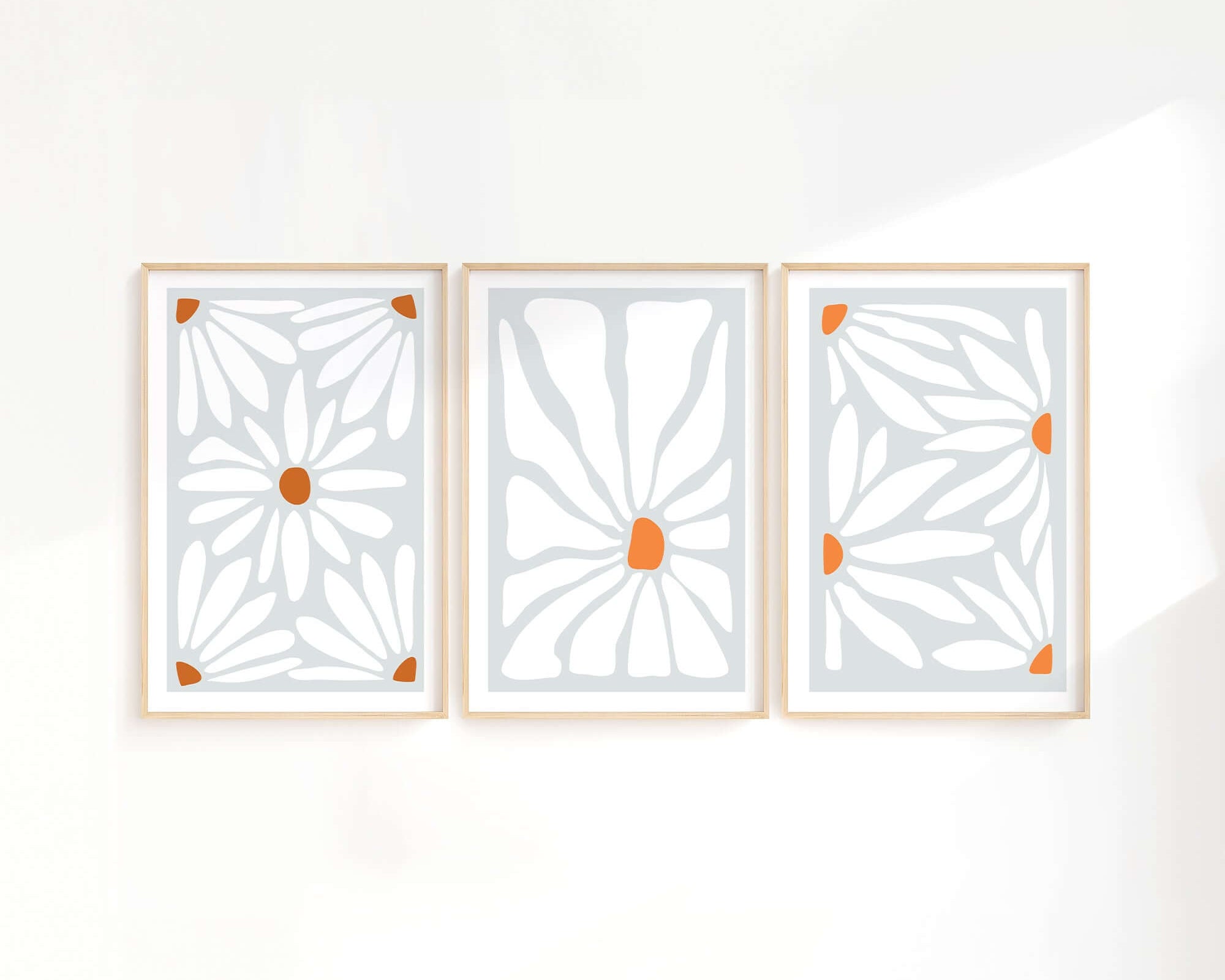 The Flower Blocks Triptych | Set of Three Prints | 014 features abstract floral designs in orange and white, elegantly framed in wood—perfect wall art to elevate your home decor.