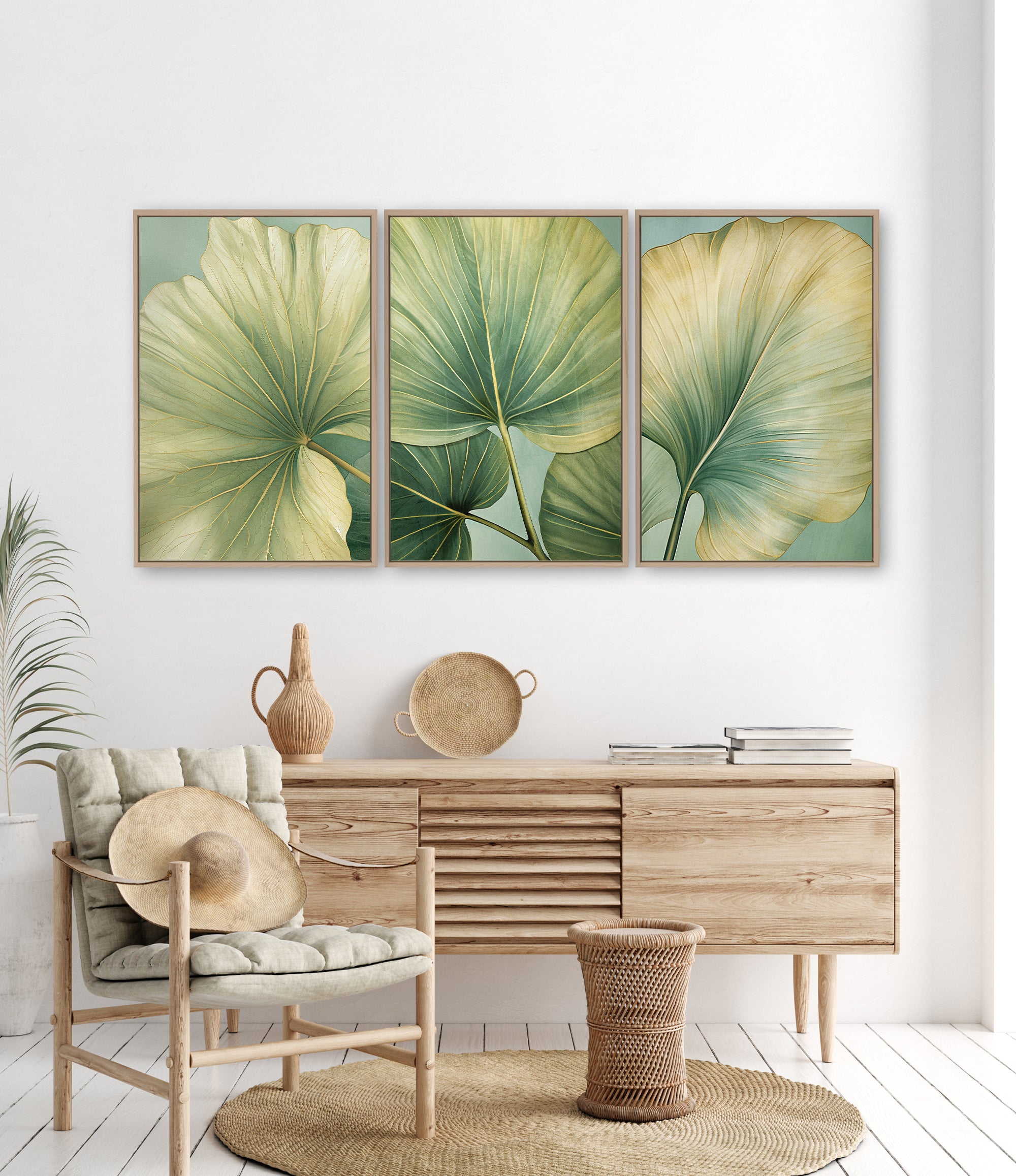 a living room with a wooden dresser, a woven basket, and a woven chair. Above the dresser, there are three framed prints of large green leaves on a white wall.