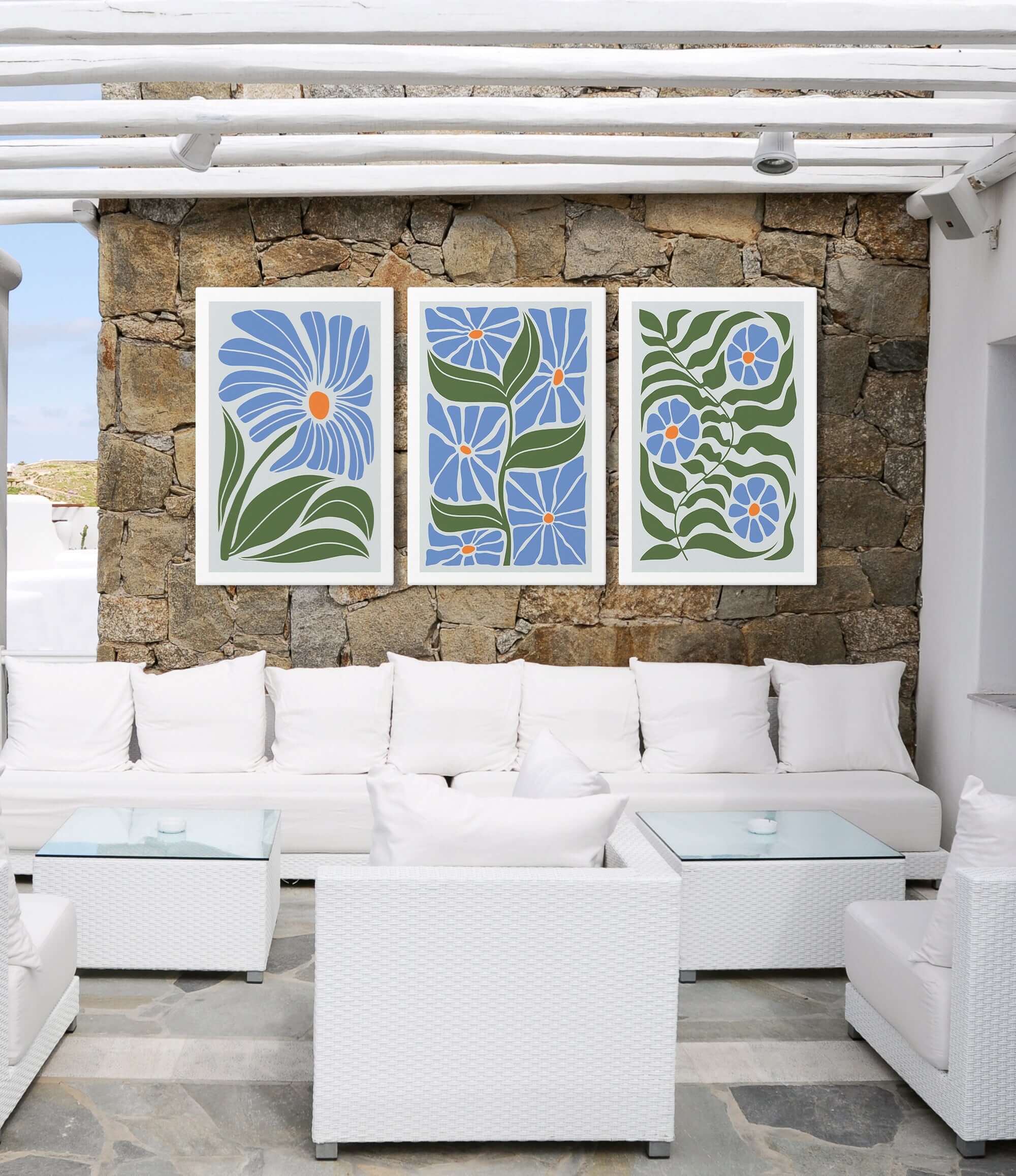 a living room filled with white furniture and a stone wall