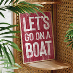 a sign that says let&#39;s go on a boat on a shelf