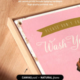 a pink canvas with the text "Please don't forget to wash your hands" written on it. The canvas is framed in a natural frame, and there is a small arrow pointing to the bottom right corner of the canvas.