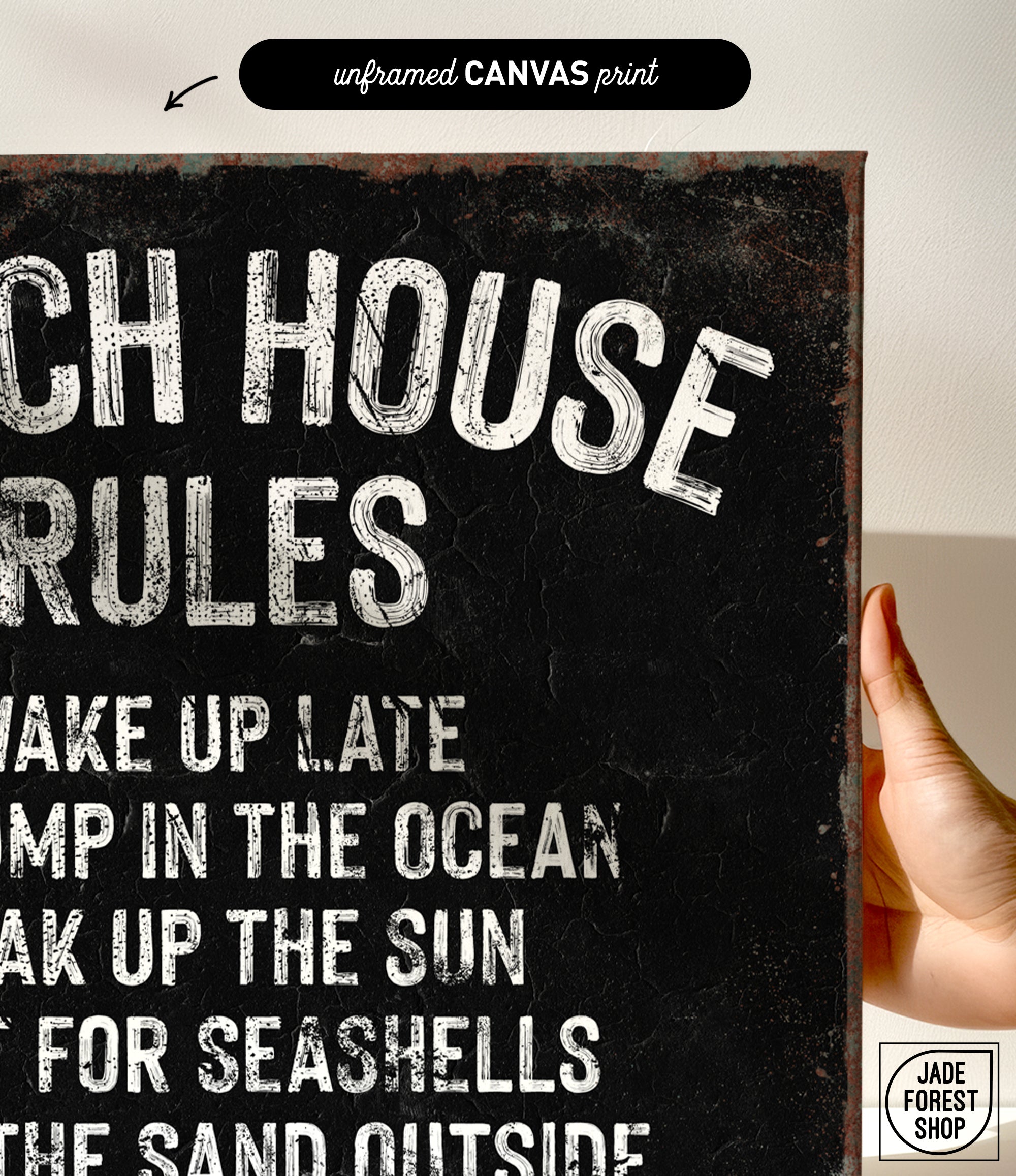 a hand holding a sign that says beach house rules