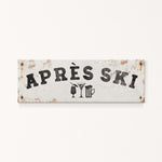 A weathered sign with the text "APRÈS SKI" and icons of a beer mug and a martini glass.