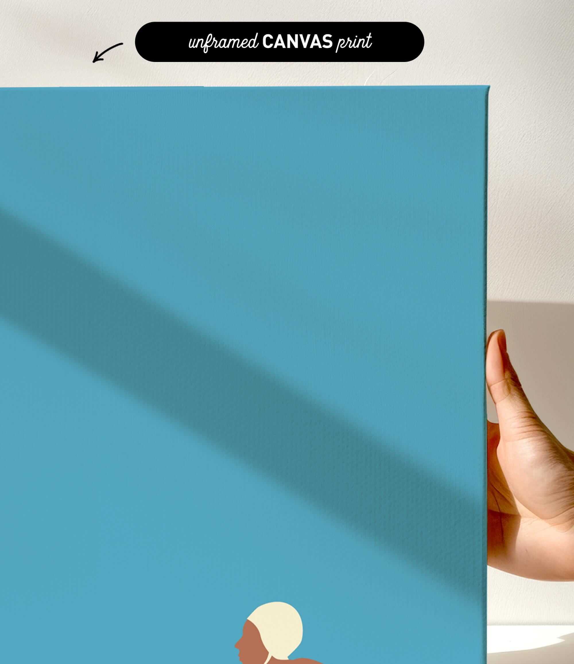 The image is a hand holding a blue canvas print with a white line running across it.