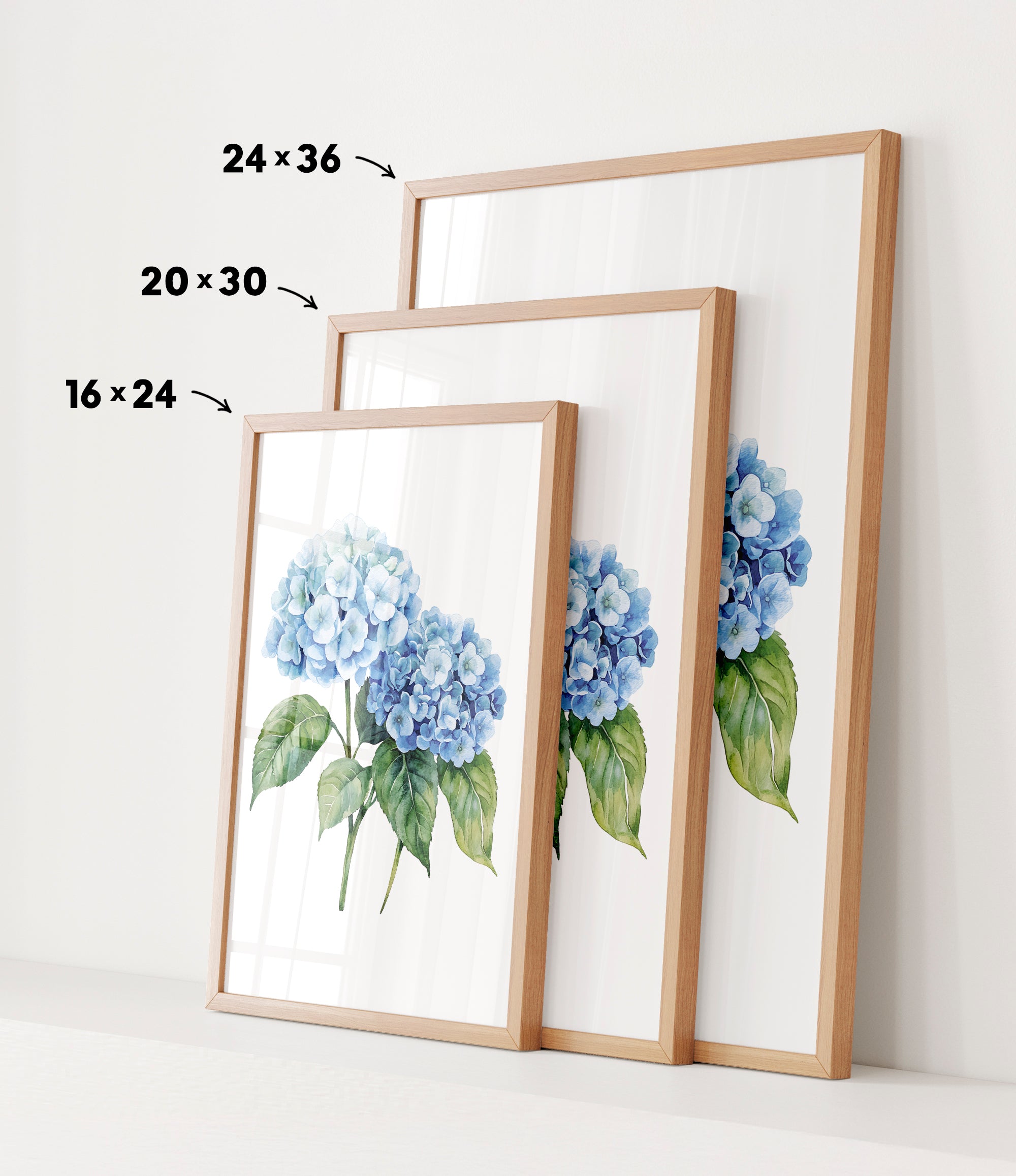 three framed watercolor paintings of blue hydrangea flowers, each with a different size and frame.