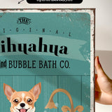 a hand holding a framed print with a dog and a sink, along with text that reads "The original bubble bath co."