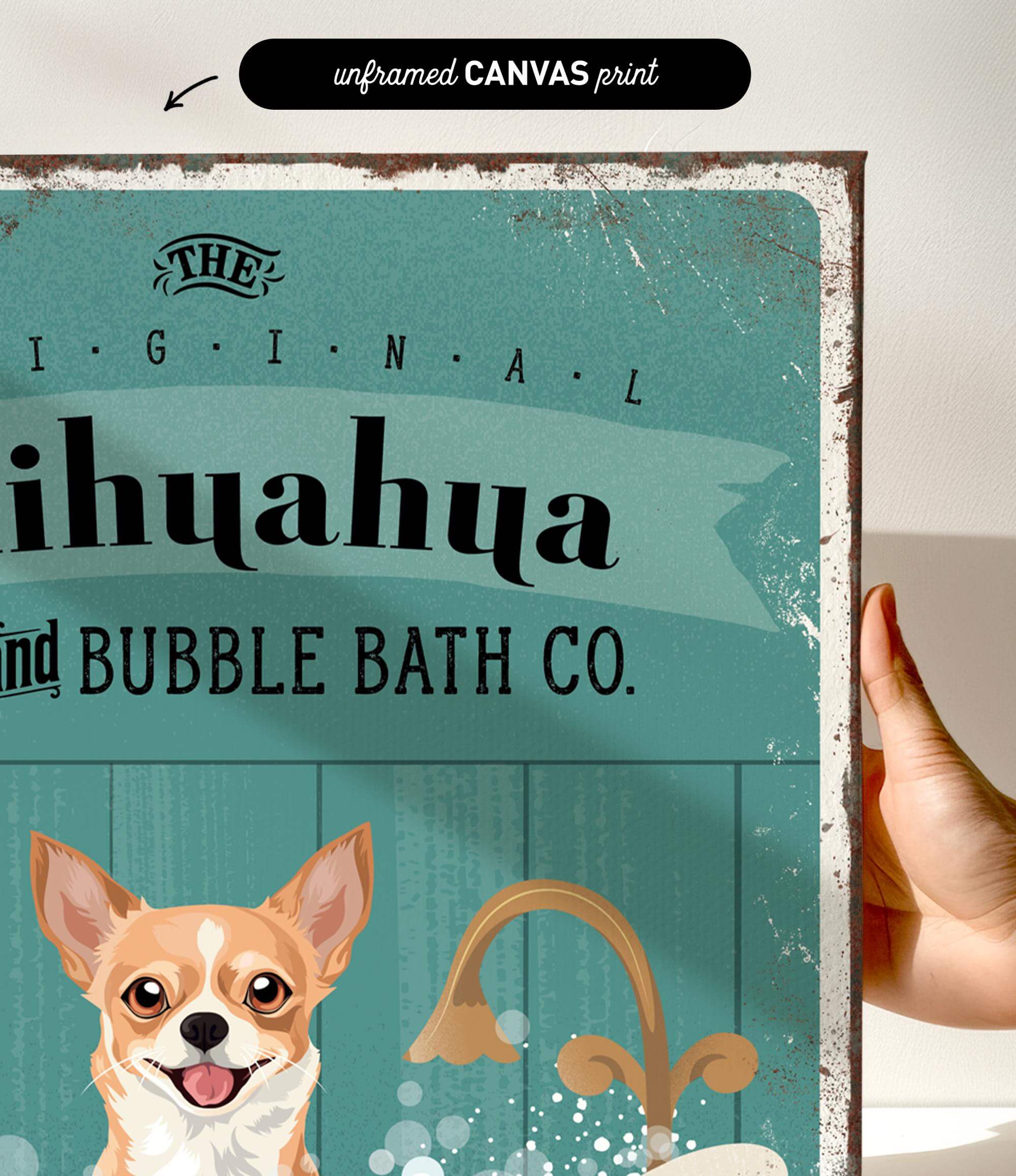 a hand holding a framed print with a dog and a sink, along with text that reads "The original bubble bath co."