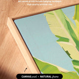 a close-up view of a framed artwork with a vibrant green and yellow tropical plant depicted on the canvas.