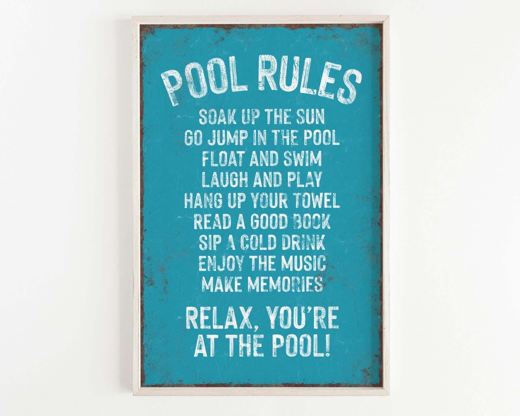 a picture of a pool rules sign hanging on a wall