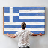 a man standing in front of a painting of the flag of greece