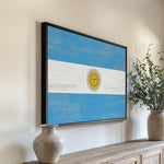 a painting of the flag of argentina hangs on a wall