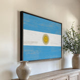 a painting of the flag of argentina hangs on a wall