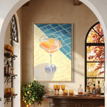a cozy and inviting bar setting with a wooden bar counter, two stools, and a large painting of a cocktail glass on the wall. The bar is surrounded by potted plants and cacti, creating a warm and relaxing atmosphere.