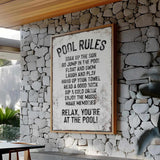 a sign on a stone wall that says pool rules