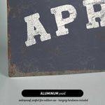 The image is an aluminum print with the text "APR" in white letters on a dark background.