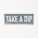 a wooden sign that says take a dip