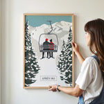 A woman is standing in front of a framed poster depicting a ski lift with two people riding it.