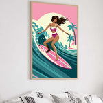 A framed illustration of a woman surfing on a pink surfboard against a colorful background.