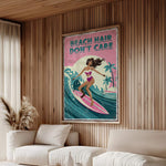 a poster with a woman surfing on a pink surfboard, with the text "BEACH HAIR DON'T CARE" written on it. The poster is hanging on a wooden wall in a living room setting.