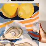 The image is a vibrant and colorful painting featuring a variety of fruits and vegetables, including two lemons, an oyster shell, and a piece of bread. The painting is framed and appears to be a canvas print.