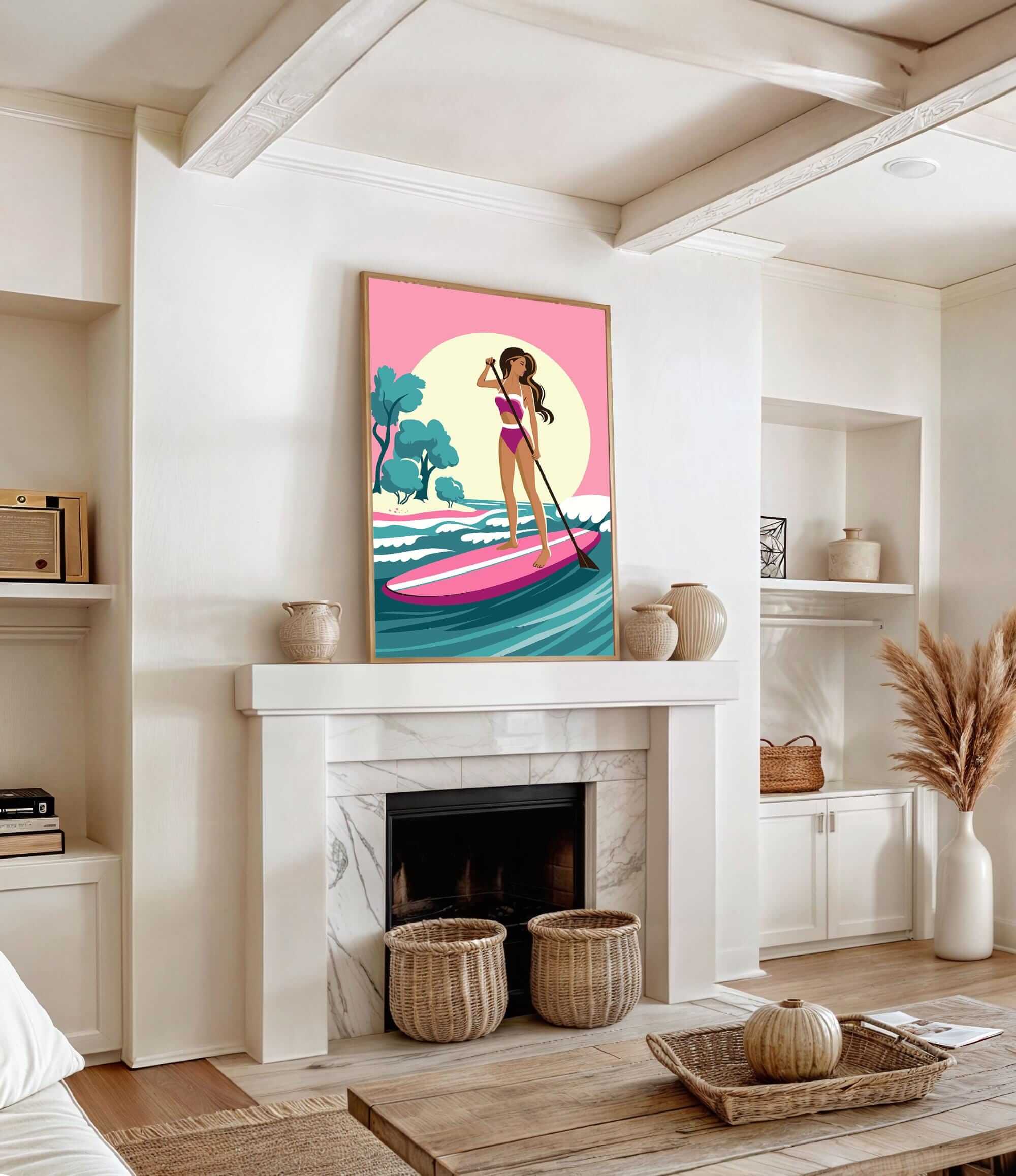 a living room with a fireplace, a large framed poster of a woman paddleboarding, and various decorative elements such as vases and a potted plant.