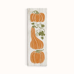 a wooden sign with three pumpkins on it