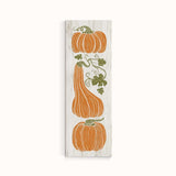 a wooden sign with three pumpkins on it