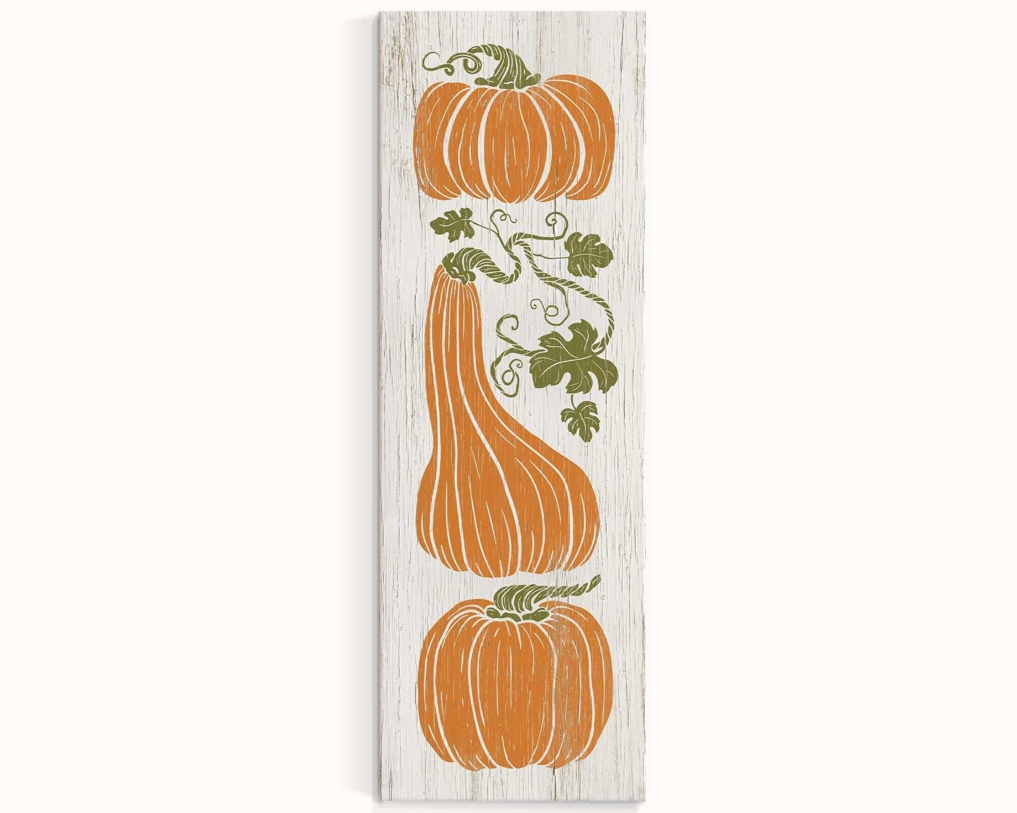 a wooden sign with three pumpkins on it