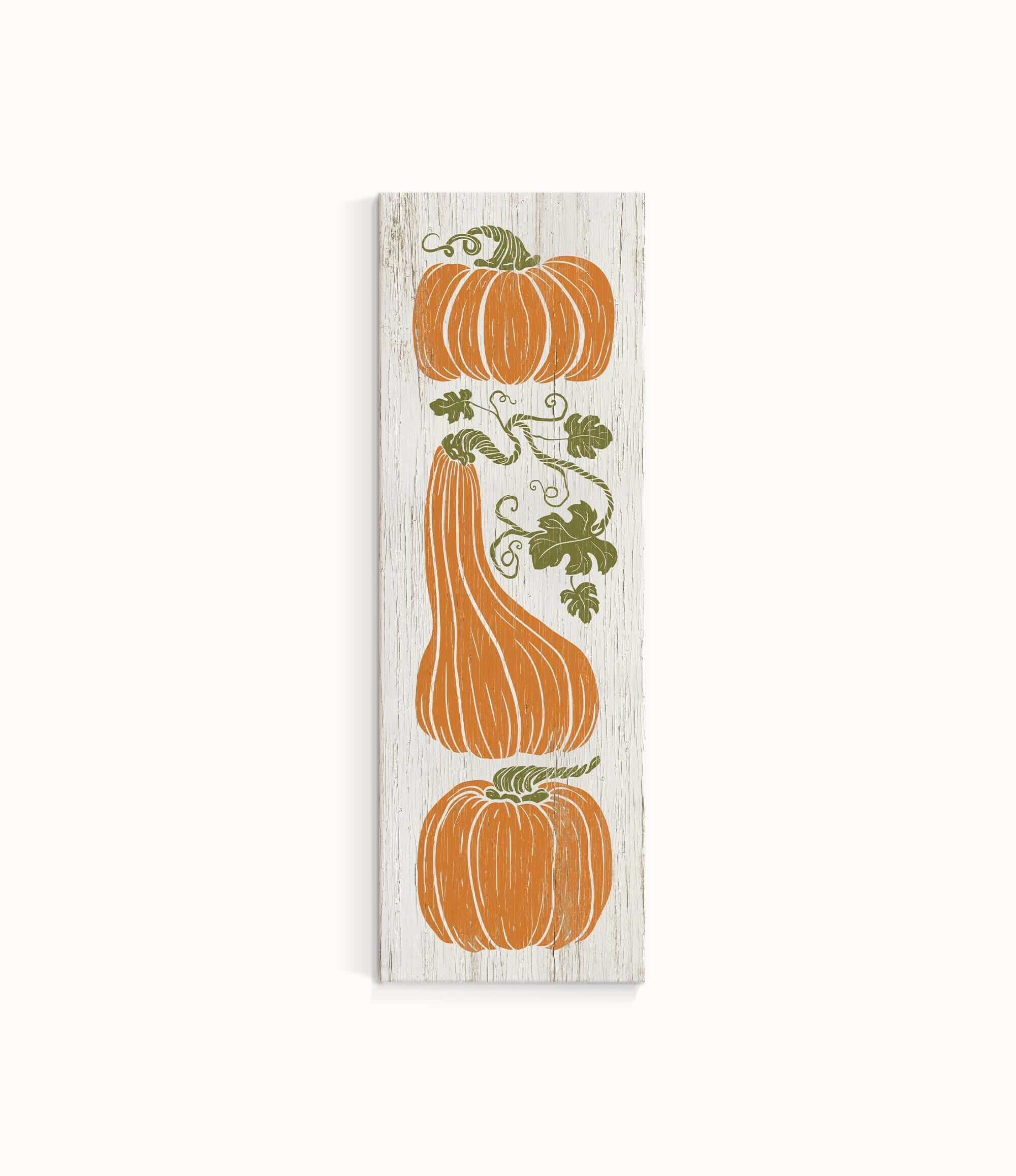 a wooden sign with three pumpkins on it