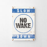 a sign that says slow no wake down