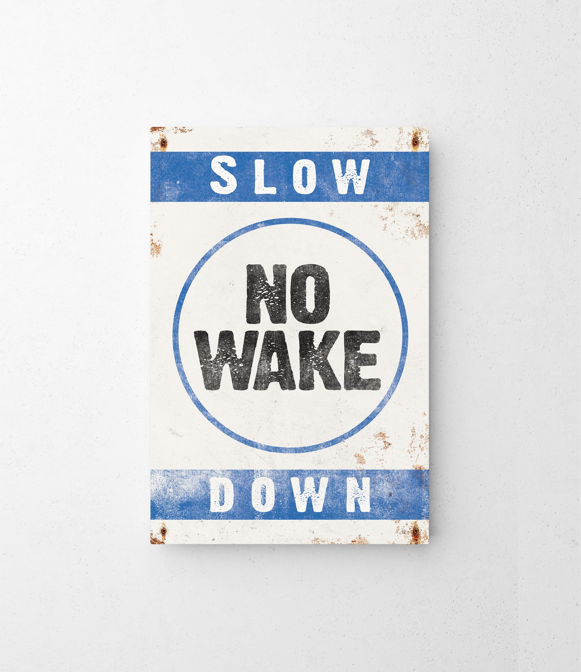 a sign that says slow no wake down