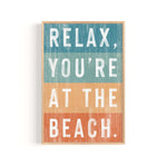 a wooden sign that says relax you're at the beach