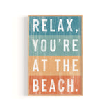 a wooden sign that says relax you're at the beach