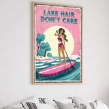 a framed poster with a woman paddleboarding on a lake, with the text "LAKES DON'T CARE" written above her.