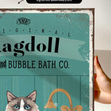 a hand holding a sign that says ragdol and bubble bath co