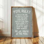 a pool rules sign sitting on top of a wooden floor