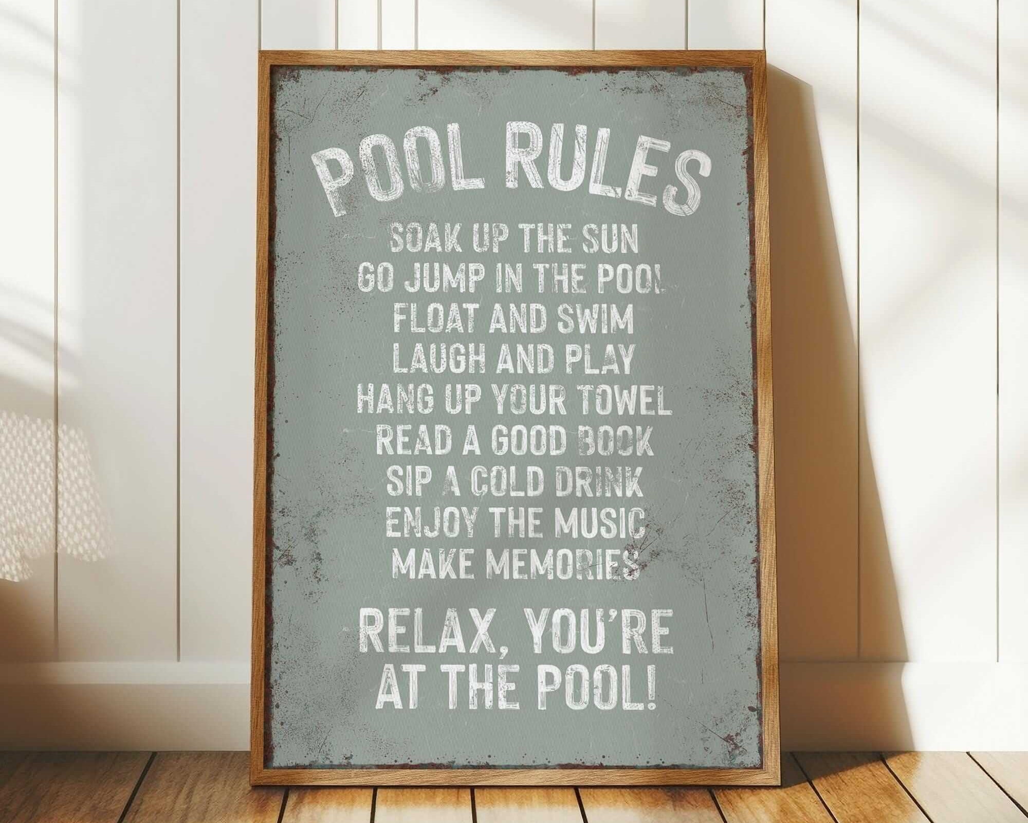 a pool rules sign sitting on top of a wooden floor
