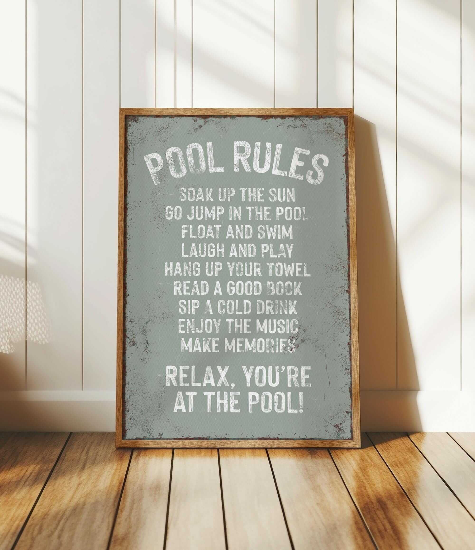 a pool rules sign sitting on top of a wooden floor