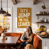 A woman sits on a red couch in a cozy kitchen, with a wooden sign above her that reads "Let's JUMP IN THE LEAVES".