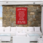 a white couch sitting under a red sign on a stone wall