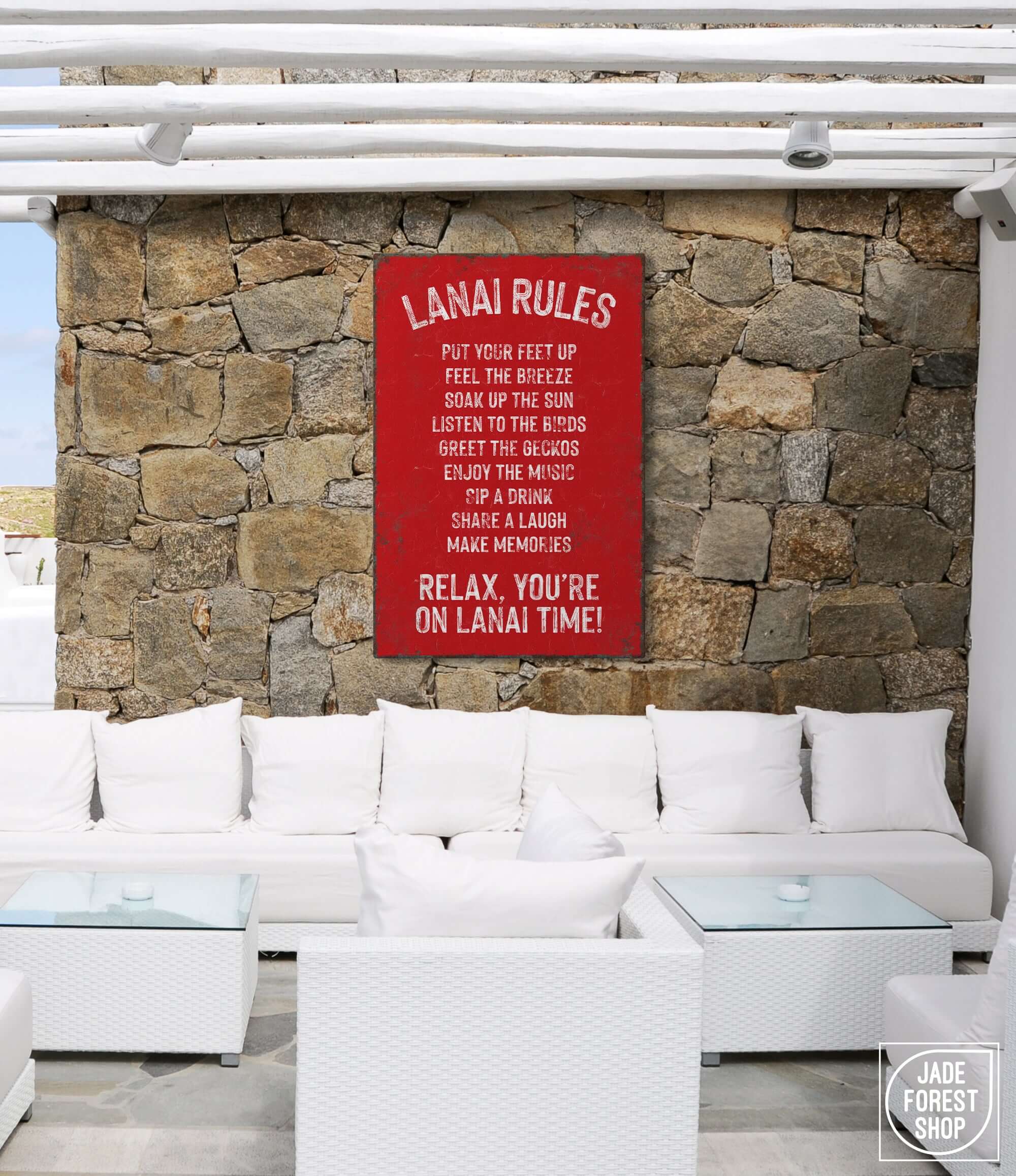 a white couch sitting under a red sign on a stone wall