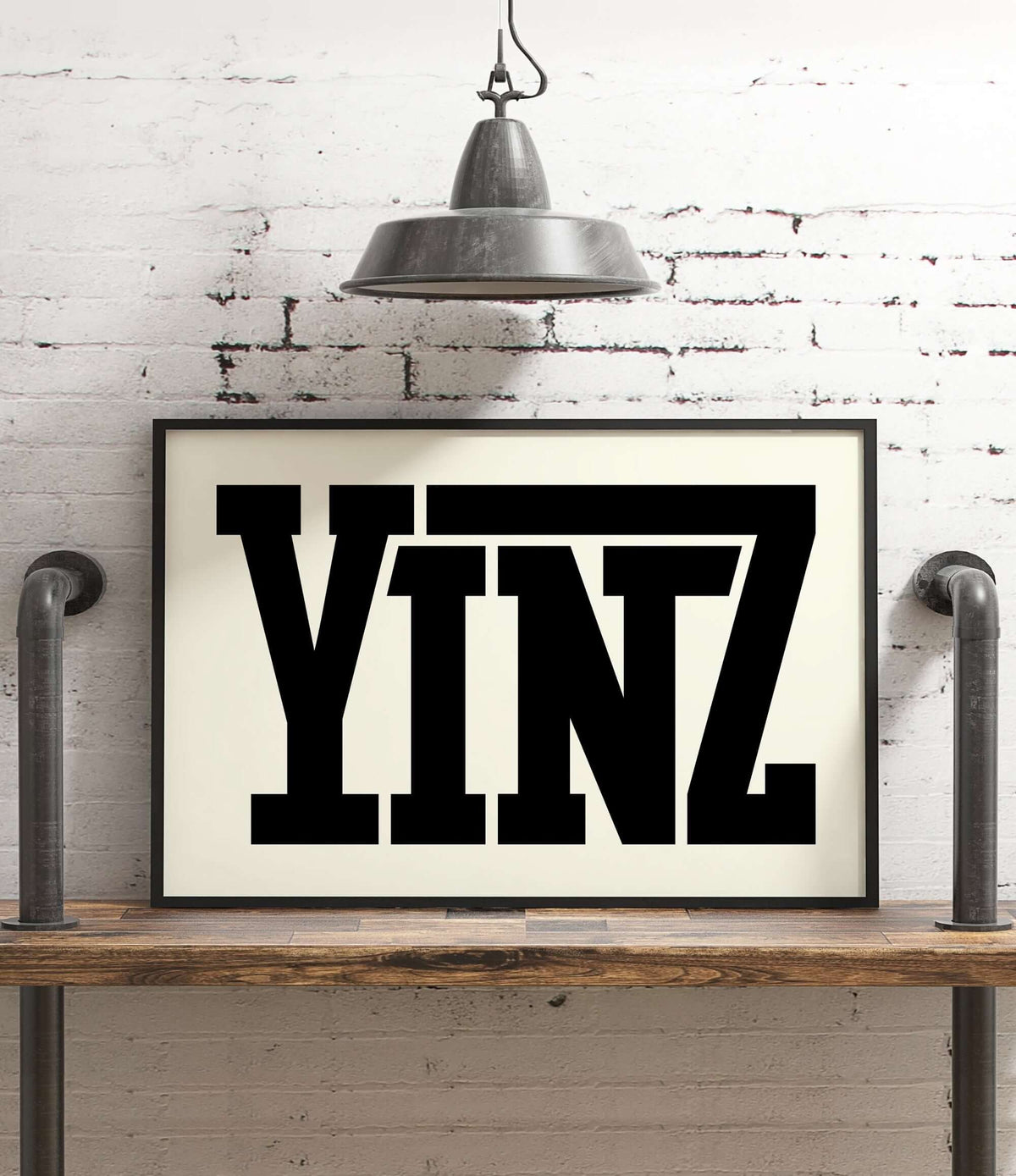 The Yinz Sign Print in off white, featuring bold black letters, adds a touch of modern farmhouse charm to your home decor when displayed under an industrial lamp or on a shelf.
